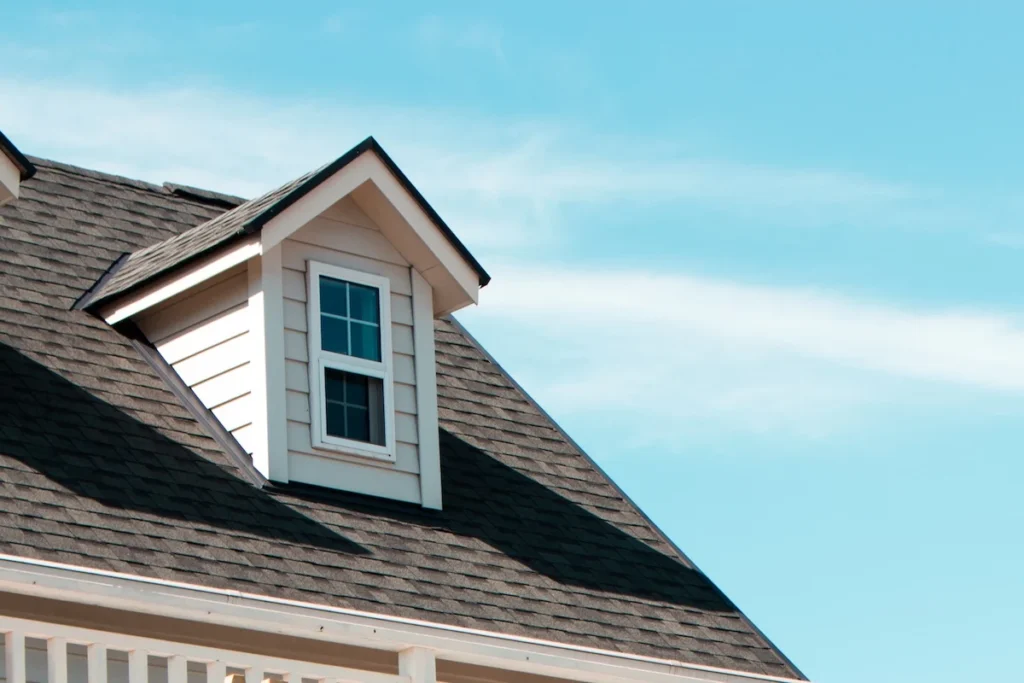 Gable dormer and roof covered in dark asphalt shingles, an example of a financed roofing upgrade.