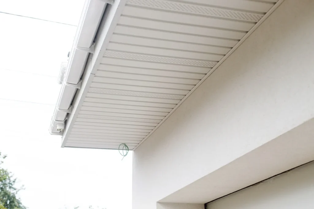 Exterior view showing white vented aluminum or vinyl soffit panels installed under an eave.
