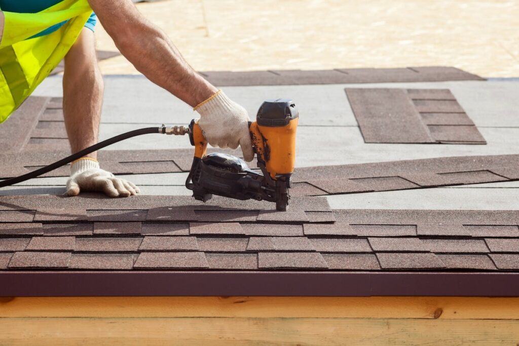 nailing-in-shingles-on-roof