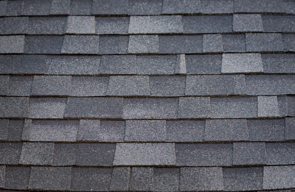 A close-up comparison of architectural shingles vs 3 tab shingles, highlighting the multi-dimensional, layered texture of the architectural style installed by The Roof Tiger.