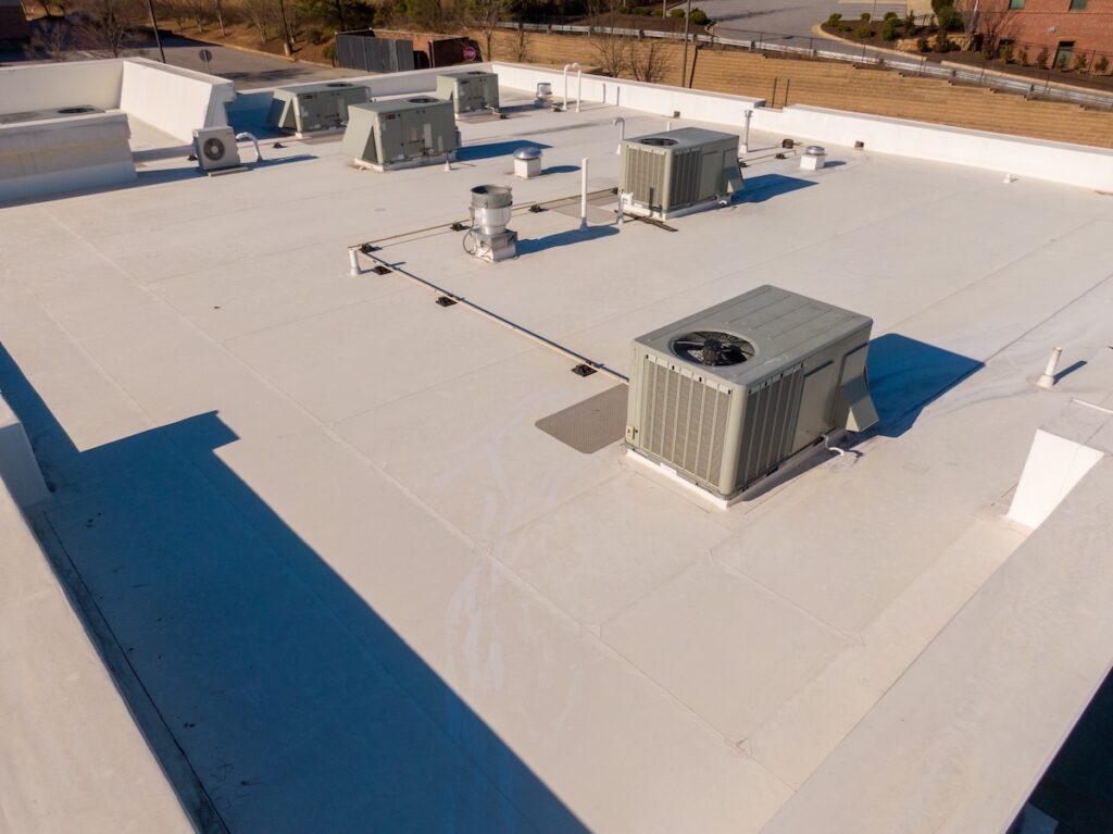 epdm vs tpo Sunny Day Time Drone Images of a TPO Roof on a Commercial Building.