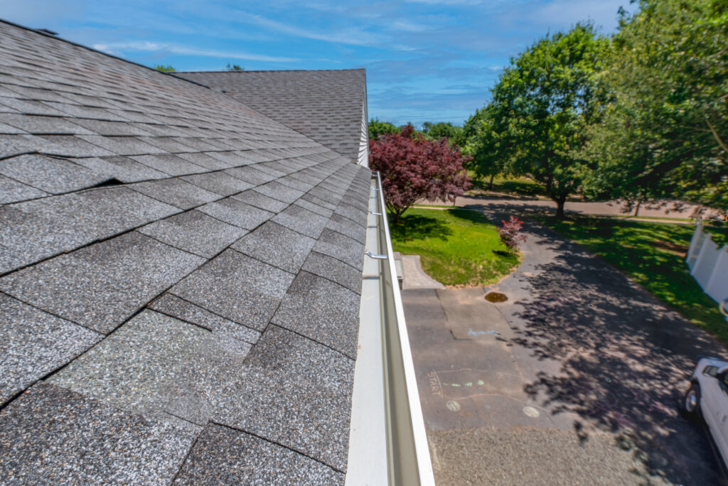 gutter installation Cleaned gutters early spring that had not been cleaned last fall. Aluminum gutters that have been cleaned and flushed with water so that they gleam. Looking the length of the gutter home maintenance