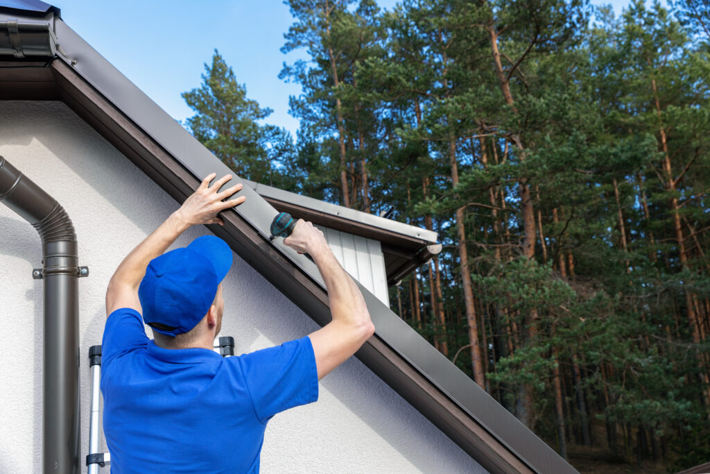 roofing companies in peoria heights roofer installing metal drip edge profile on the house roof