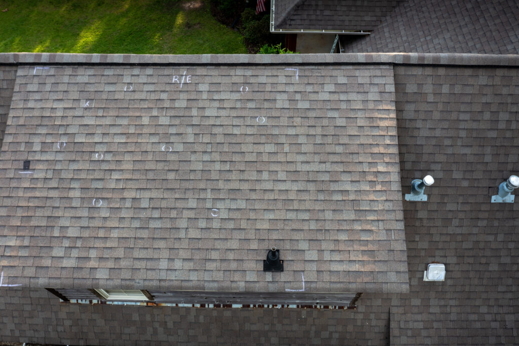 insurance roof replacement Roof with hail damage and chalk markings from inspection