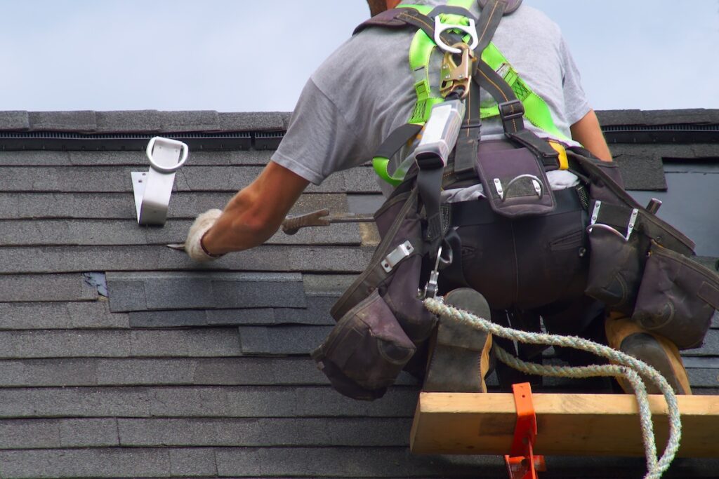 roof repair construction worker roofer man roofing security rope