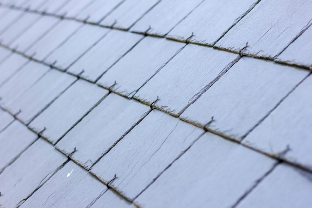 A close up portrait of a blue, black slate tile roof