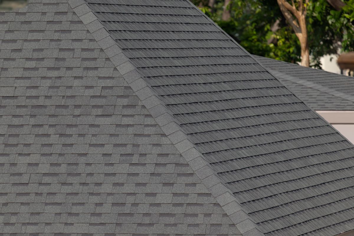 Dark gray shingles line a sloped roof, with neat rows. Energy efficiency